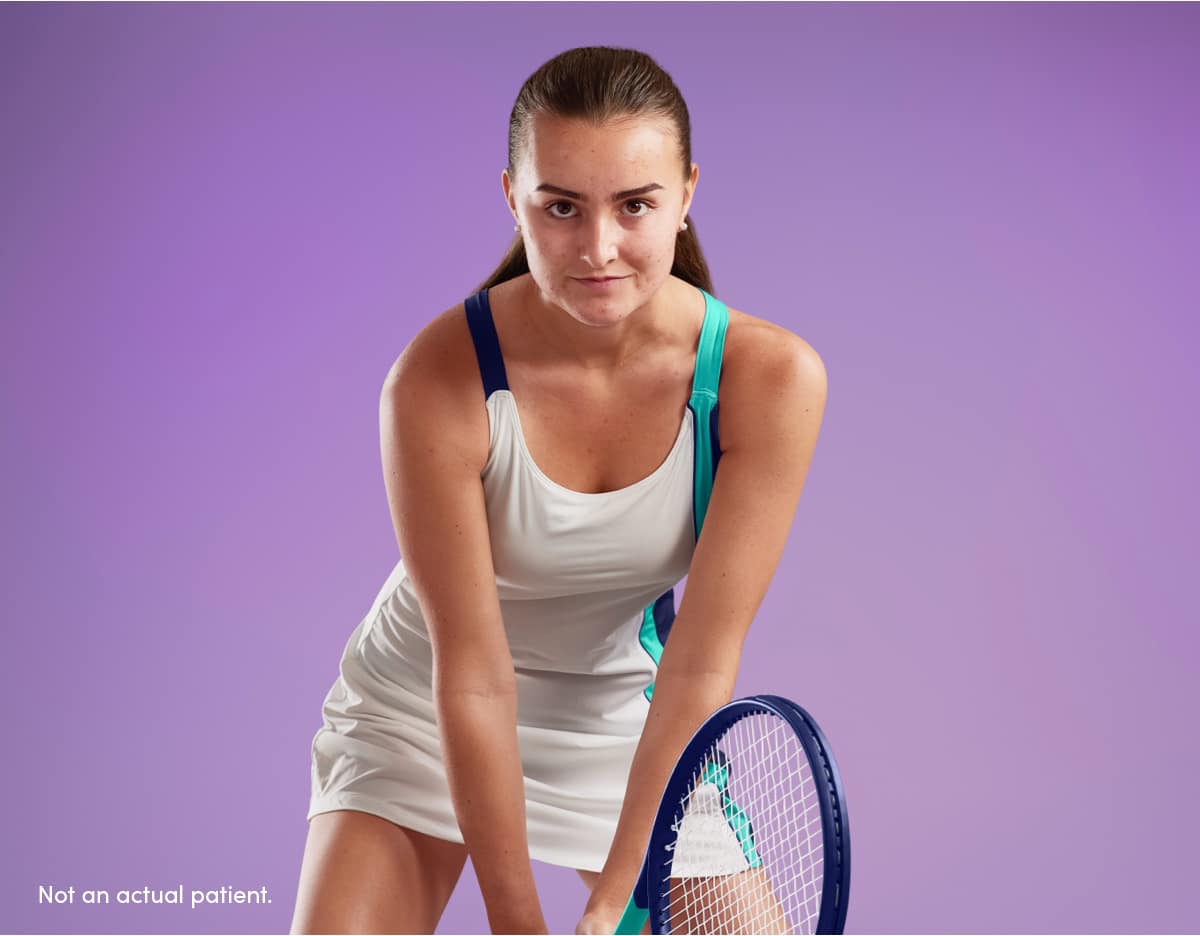 Teenage girl determined to return tennis serve represents confidence having clearer skin using AKLIEF® Cream acne medication